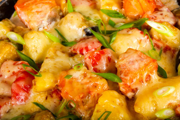 Baked salmon with potato in pan