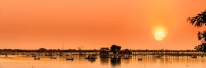 The silhouette of U Bein Bridge, the oldest and longest teakwood bridge in the world across the...