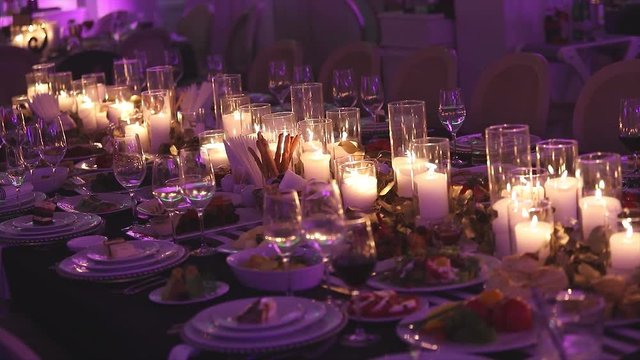 Decorative candles on the dining table, glasses and Christmas candles on the table, white wax candleswith glass candlestick, Candle with Glass Candlestick, restaurant, interior, close-up