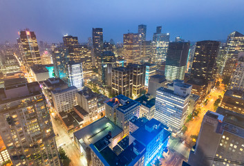 Fototapeta premium Night aerial view of Vancouver skyscrapers from city rooftop - British Columbia, Canada