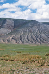Mongolian mountain natural landscapes with eroded foothill slopes near lake Tolbo-Nuur in north Mongolia