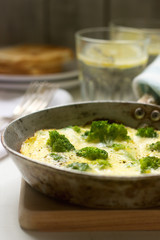 Omelette with broccoli and cheese served with bread toasts and lemonade.