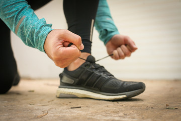Fototapeta premium Man tying shoes before running.