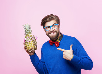 Funny man posing with pineapple.