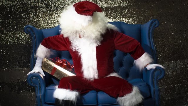 father christmas wakes up late and has trouble getting out of his chair