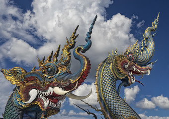 Fototapeta premium Dragon statues at Wat Rong Suea Ten Blue Temple Chiang Rai Thailand
