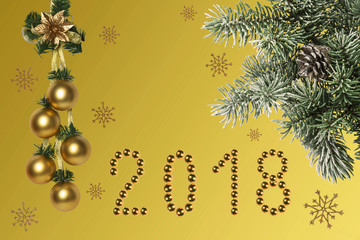 Christmas holidays composition on gold background with with a branch of spruce covered with snow and a place for your text