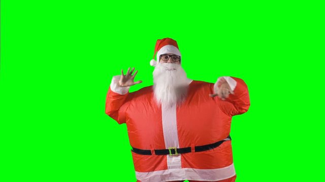 Santa Claus makes horizontal hand moves on a green background. 