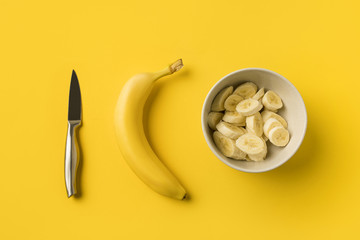 Plate with cut bananas and knife