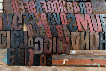 black, red and brown fonts made of wood and embossed in a wooden wall. stamps placed on a wooden wall. Different typed letter letters with different styles, bold, plain and italic