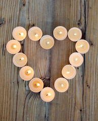 Heart shape made from burning candles