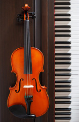A violin next to the piano keyboard