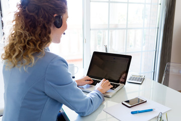 Customer service operator talking on phone in the office.