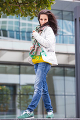 Portrait of a beautiful girl in an urban landscape in autumn