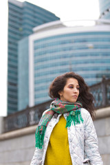 Portrait of a beautiful girl in an urban landscape in autumn