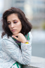 Portrait of a beautiful girl in an urban landscape in autumn