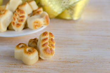 Close up of Spanish Christmas marzipan sweets, Figuritas de mazapan with christmas decoration on wooden table. Traditional treat consumed during winter holidays in Spain.