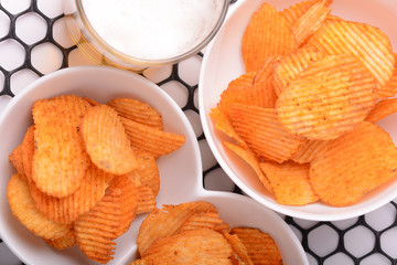 Glass of beer with nachos chips on a abstract background.
