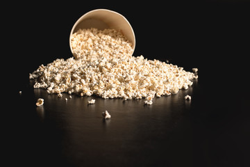 popcorn spilled from cardboard bucket