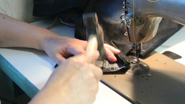 Home seamstress beats jeans with a hammer for easy sewing.