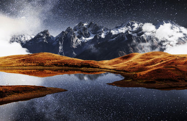 Fantastic starry sky on mountain lake Koruldi. Picturesque night Upper Svaneti, Georgia Europe....