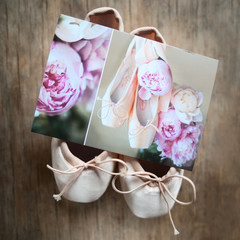 Postcard with peonies and pointe shoes lies on the pointe shoes.
