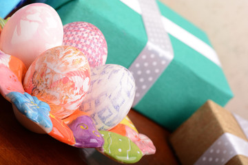 Handcrafted easter eggs close up, gift boxes , ribbons and decoration