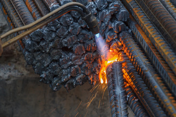 Gas cutting of metal fittings.  Sparks.
