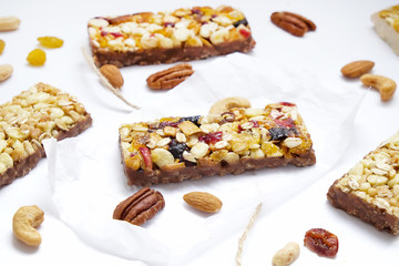 Healthy cereal granola bars with nuts and dry berries close up. 