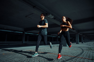 Young sports couple running in the urban environment