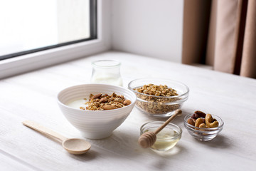 Healthy breakfast granola with nuts on window sill at home