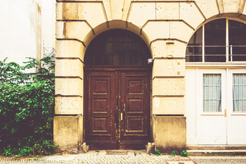 Fototapeta na wymiar old wooden entrance door on marble building