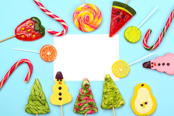 Candy lollipops on blue background with place for text