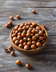 Hazelnut in a wooden bowl on a wooden table