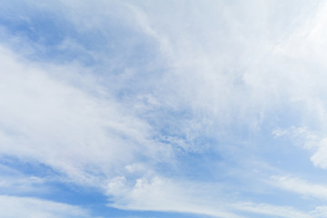 Clear blue sky background with white clouds.