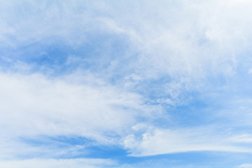 Clear blue sky background with white clouds.