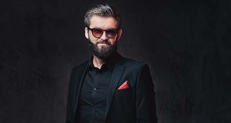 A man dressed in a suit and sunglasses.