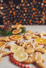 Decorating gingerbread cookies with white icing, selective focus and place for text