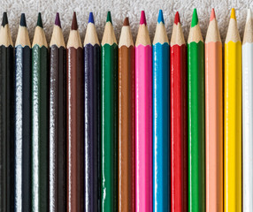 colorful pencils lined up in a row from dark on the left to bright on the right