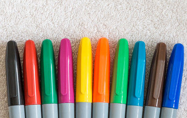 Colorful pen lids in an arc row