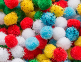 Fluffy colorful balls mixed together from above