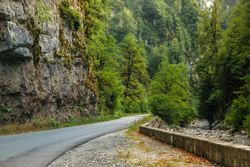 Good asphalt road through gorge along Bzyb river near Ritsa lake in Abkhazia