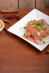 fresh salmon fillet close up on white plate. eggs, cinnamon and lemon