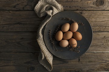 Raw Brown Eggs on a Rustic Background. Natural Wood Background.