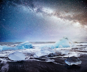 Icebergs floating in Jokulsarlon glacial lake. South Iceland. Lagoon. Starry sky night. Fantastic milky way.
