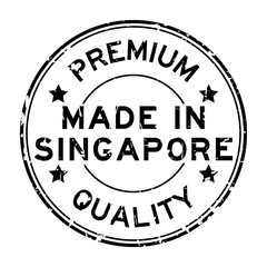 Grunge black premium quality made in Singapore round rubber business seal stamp on white background