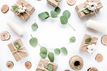 creative arrangement frame of craft boxes and green branches eucalyptus on white background. flat lay, top view