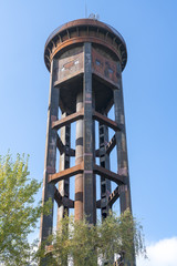 old rusty water tower and clear blue sky