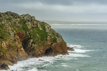 Fototapeta premium Landscape seascape long exposure with cliffs and rocks on Atlantic Ocean. 