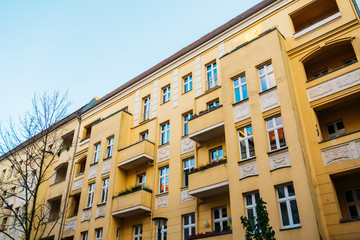 Fototapeta na wymiar typical residential building in prenzlauer berg with orange facade
